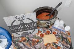 Cook wild sign next to a pot of chili