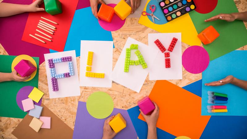 'Play' spelled out in colorful legos