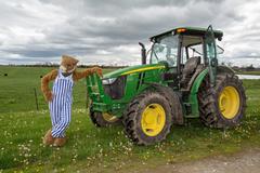 UK Wildcat leaning on John Deere tractor